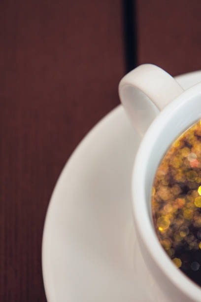 istock Black coffee in a white ceramic cup on a wooden table 1282303384