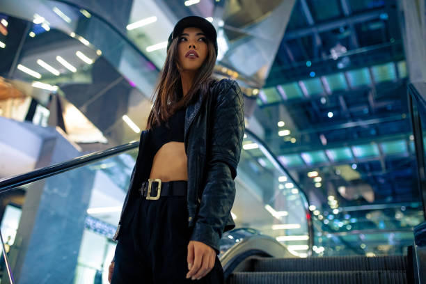 istock Woman poses on escalator in shopping mall. 1282304610
