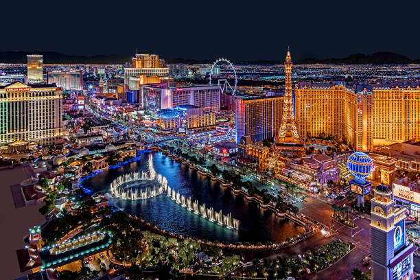 The famous Las Vegas Strip with the Bellagio Fountain. Las Vegas, USA - August 17, 2018 Panoramic view of Las Vegas strip at night in Nevada.  The Strip is home to the largest hotels and casinos in the world. the strip las vegas stock pictures, royalty-free photos & images