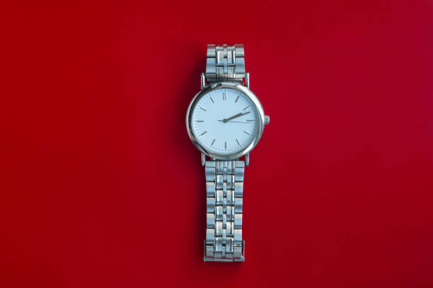 istock Silver metal watch on red background top view 1282306772