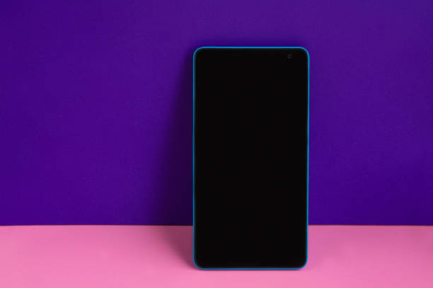 istock Blue smartphone with empty dark screen on pink and purple colourful background 1282306799