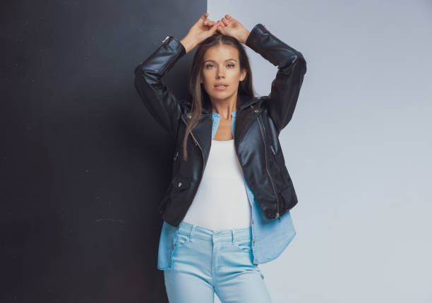 istock Beautiful fashion model holding hands above head while standing 1282306989