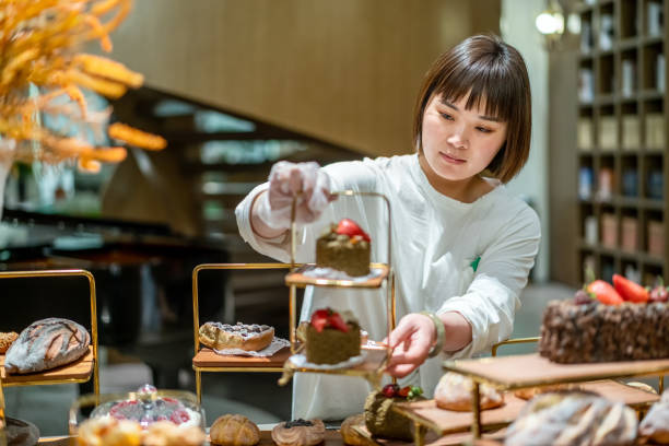 istock Young Asian female baker is working in the bakery 1282307247
