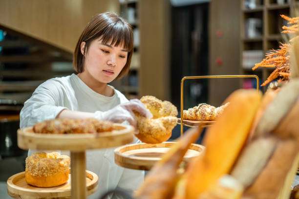 istock Young Asian female baker is working in the bakery 1282307342