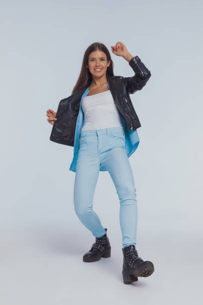 istock Happy fashion model wearing leather jacket while dancing 1282307356