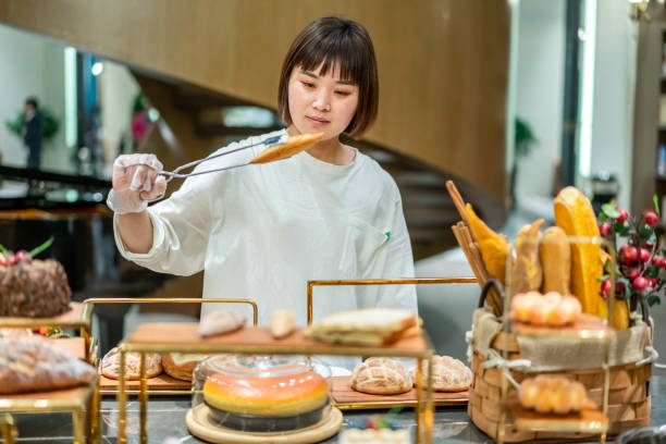 istock Young Asian female baker is working in the bakery 1282308169