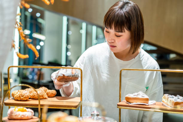 istock Young Asian female baker is working in the bakery 1282308255