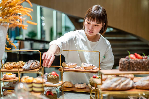 istock Young Asian female baker is working in the bakery 1282308814