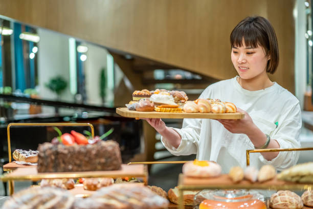 istock Young Asian female baker is working in the bakery 1282308938