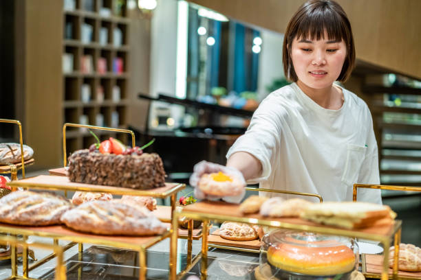 istock Young Asian female baker is working in the bakery 1282308975