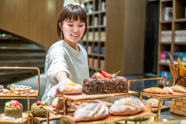 istock Young Asian female baker is working in the bakery 1282309126