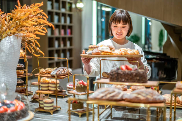 istock Young Asian female baker is working in the bakery 1282309130