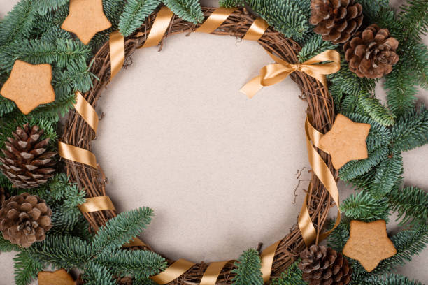 Christmas decorative wreath Christmas decorative wreath with noble fir tree twigs pine cones and gingerbread cookies on craft paper background with copy space for text 1354 stock pictures, royalty-free photos & images