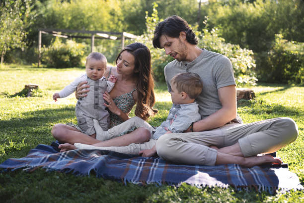 Millennial family during summertime Millennial family, chilling outdoors, during summertime, Quebec, Canada 2 5 months stock pictures, royalty-free photos & images