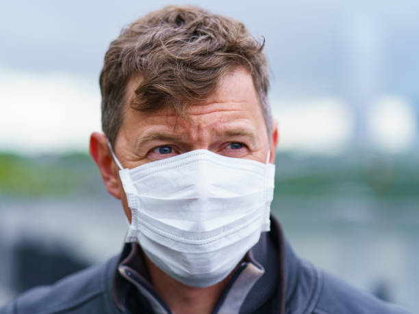 istock Handsome man wearing protective face mask outdoor 1282311720