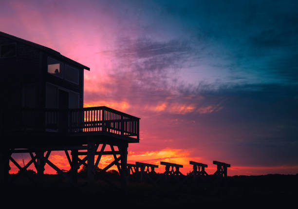 Pink and blue autumn twilight seascape over the ruined piers at the beach on Cape Cod in Massachusetts