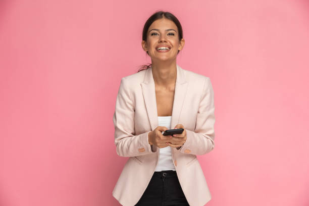 istock businesswoman texting on her mobile phone and feeling happy 1282313253