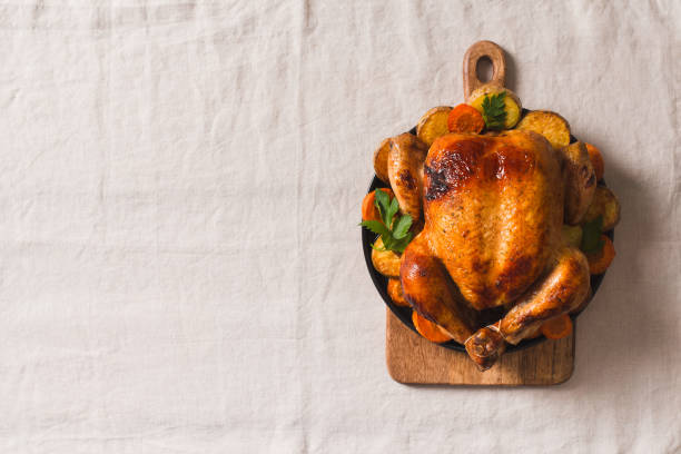 istock Fall thanksgiving table with roasting chicken or turkey on light tablecloth 1282313493