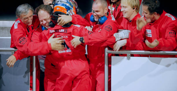 Pit crew and racing driver celebrating his victory.