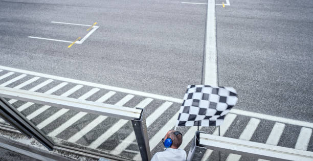 istock Auto race official waving checkered flag 1282313570