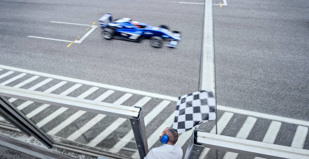 istock Auto race official waving checkered flag 1282313594