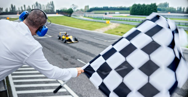 istock Auto race official waving checkered flag 1282313598
