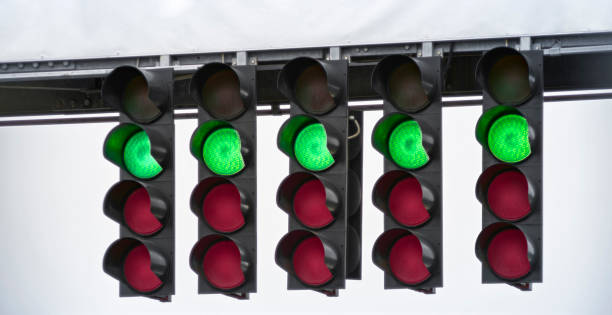 Start lights in racing circuit Close-up of green start lights in racing circuit. green light stoplight stock pictures, royalty-free photos & images