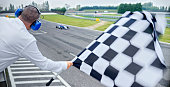 Auto race official waving checkered flag
