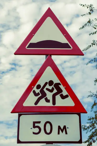 Photo of Red-white road signs against the dramatic sky.