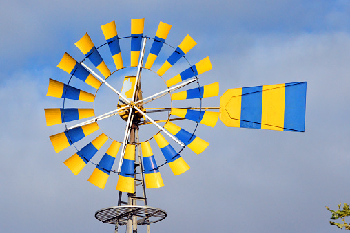 Telheiras, Lisbon, Portugal: colourful multi-bladed windpump on a old farm - windmill used to pump water - aka wind turbine