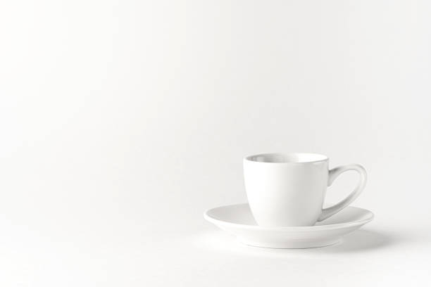 istock White coffee cup and saucer on a white background. Minimalistic design 1282314859