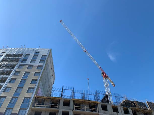 istock A building under construction with a construction crane and a ready-made house nearby 1282314964