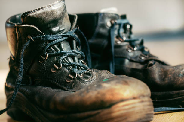 istock Old worn-out workman's shoes. Shoes that require repair or replacement 1282315863
