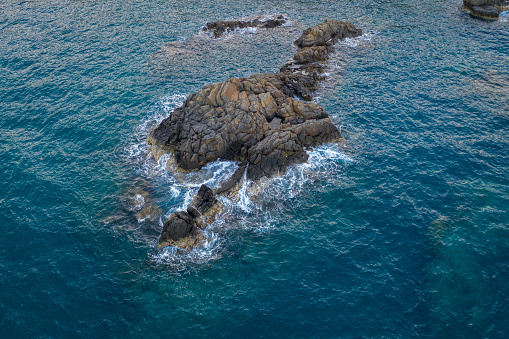 Drone view of rock island on the sea