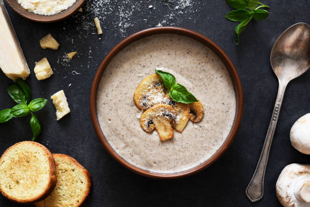 Soup puree with mushrooms and cheese on a concrete background. stock photo