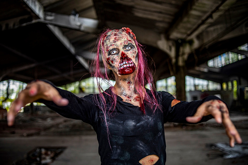 A close-up of a woman in zombie makeup - Zombie portrait - Horror scenes and stage makeup