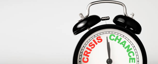 istock Crisis and chance concept in black alarm clock concept. 1282318921