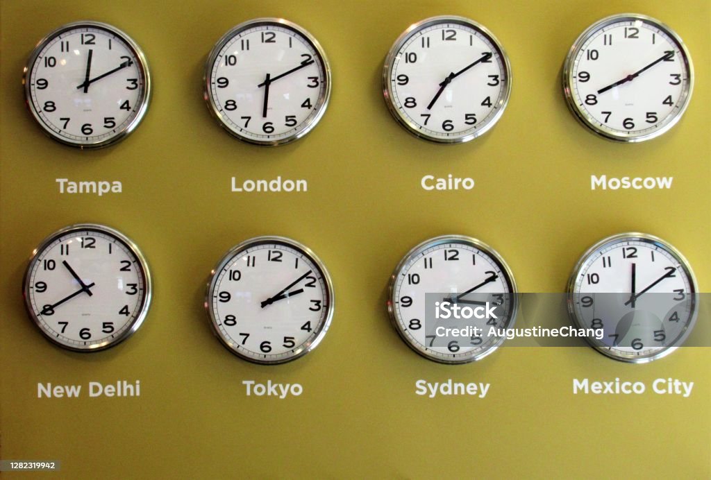 International clocks Set of wall clocks showing the time in different places in the world. Time Zone Stock Photo