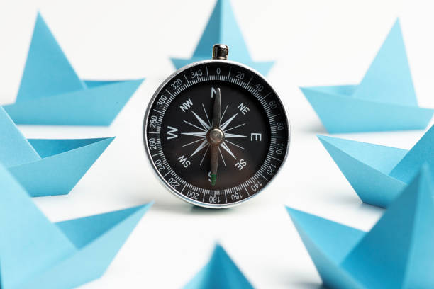 istock Blue Paper Boats With Compass 1282319999