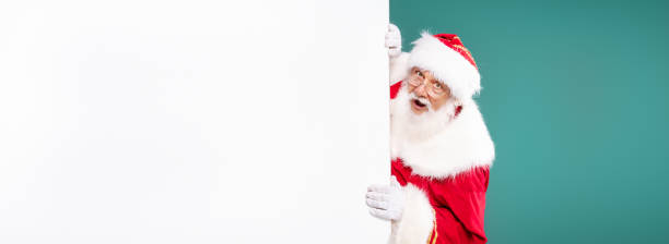 istock Real Santa Claus next to white empty board. 1282320222