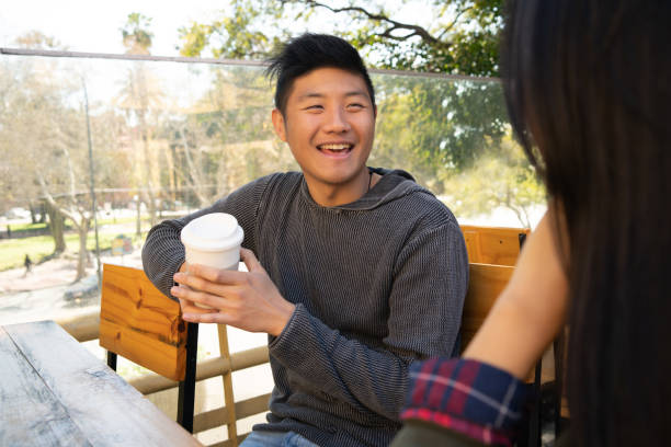 istock Asian couple at coffee shop. 1282320461