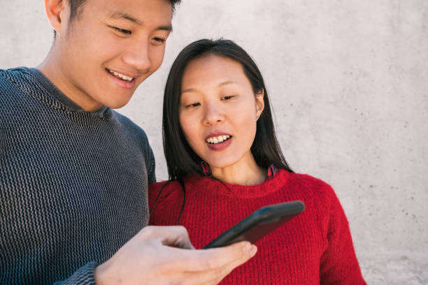 istock Asian couple looking at the mobile phone. 1282320468