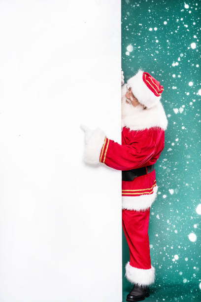 istock Real Santa Claus next to white empty board. 1282321245