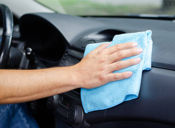 istock Cleansing car interior. Male hand  disinfecting vihicle inside 1282321645