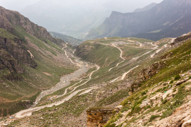 istock A road winding down a beautiful green valley 1282321898