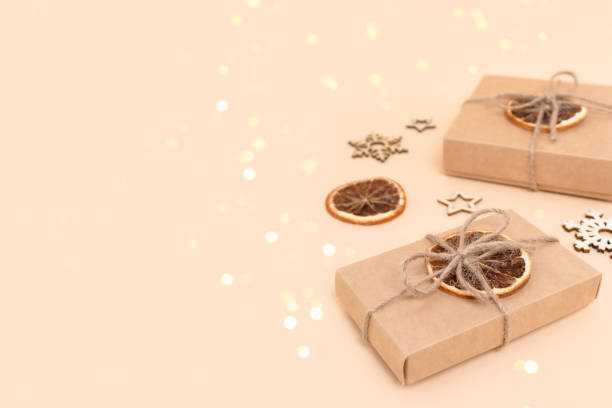 wrapped gift boxes and wooden new years toys on a beige background. - 13427 imagens e fotografias de stock