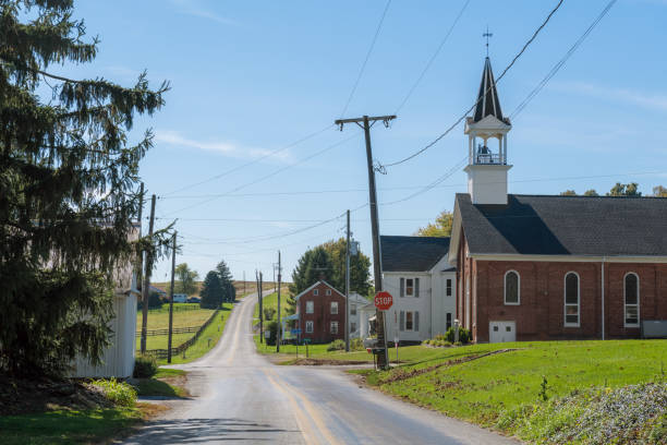 Small Town America A country road passes a church and farmland in rural York County Pennsylvania. rural main street stock pictures, royalty-free photos & images
