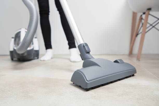 istock Woman use vacuum cleaner at the floor 1282324377