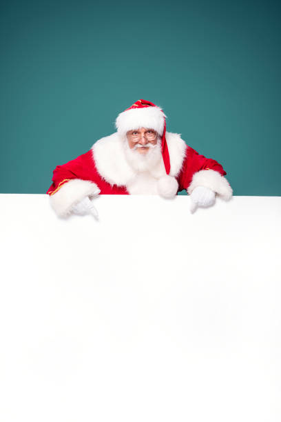 istock Real Santa Claus showing white empty board. 1282324508