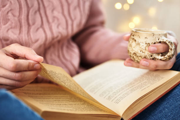 istock Woman sitting and reading a book. Relaxing concept 1282324845